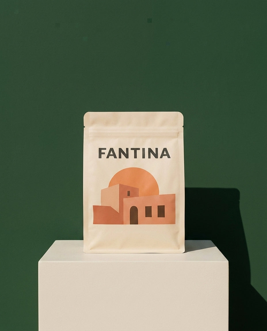 Fantina single-origin Oaxaca coffee on a bone-white plinth against a deep green wall.